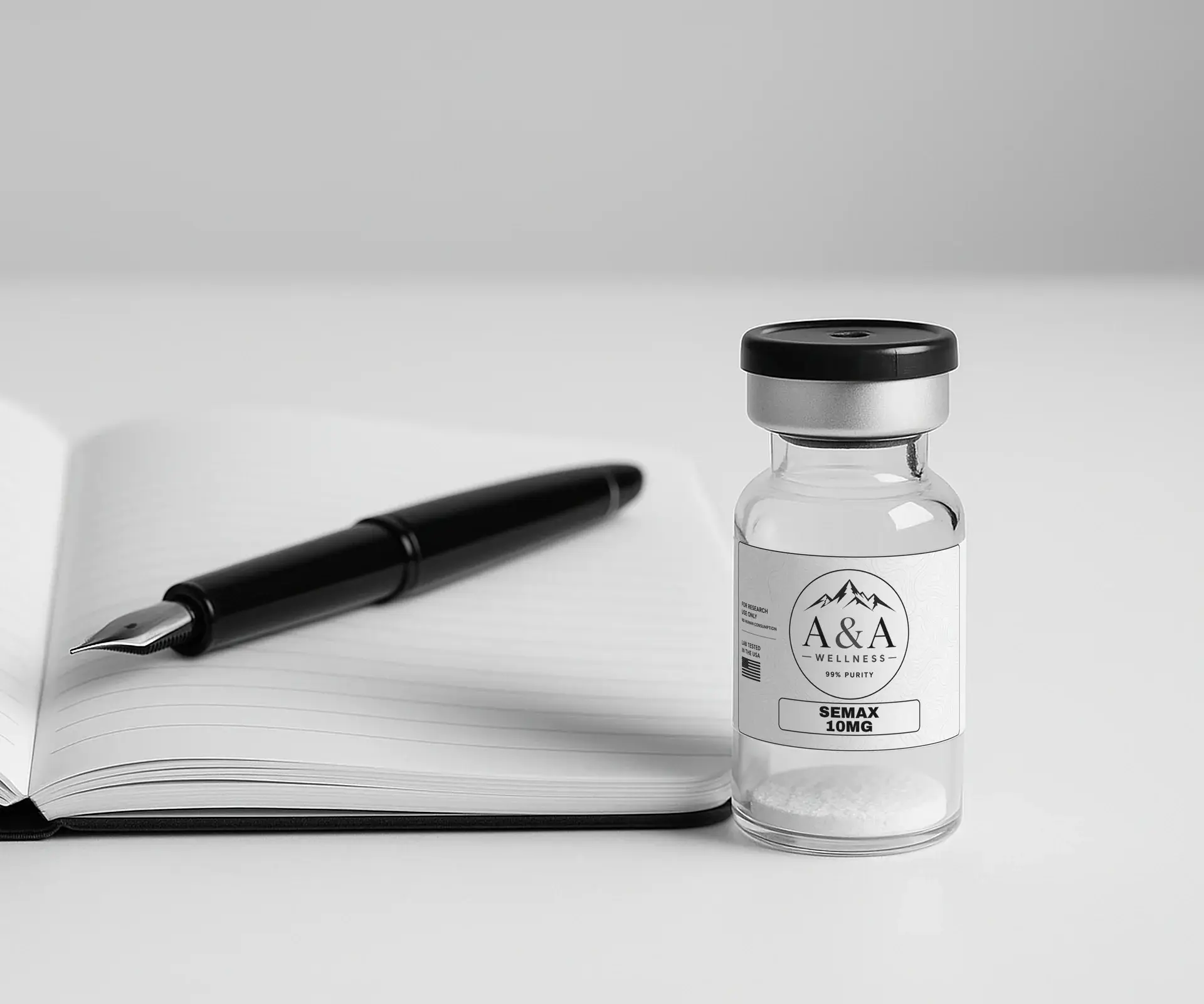 Open laboratory notebook with blank ruled pages, a fountain pen and an A&A Wellness research vial on a white desk