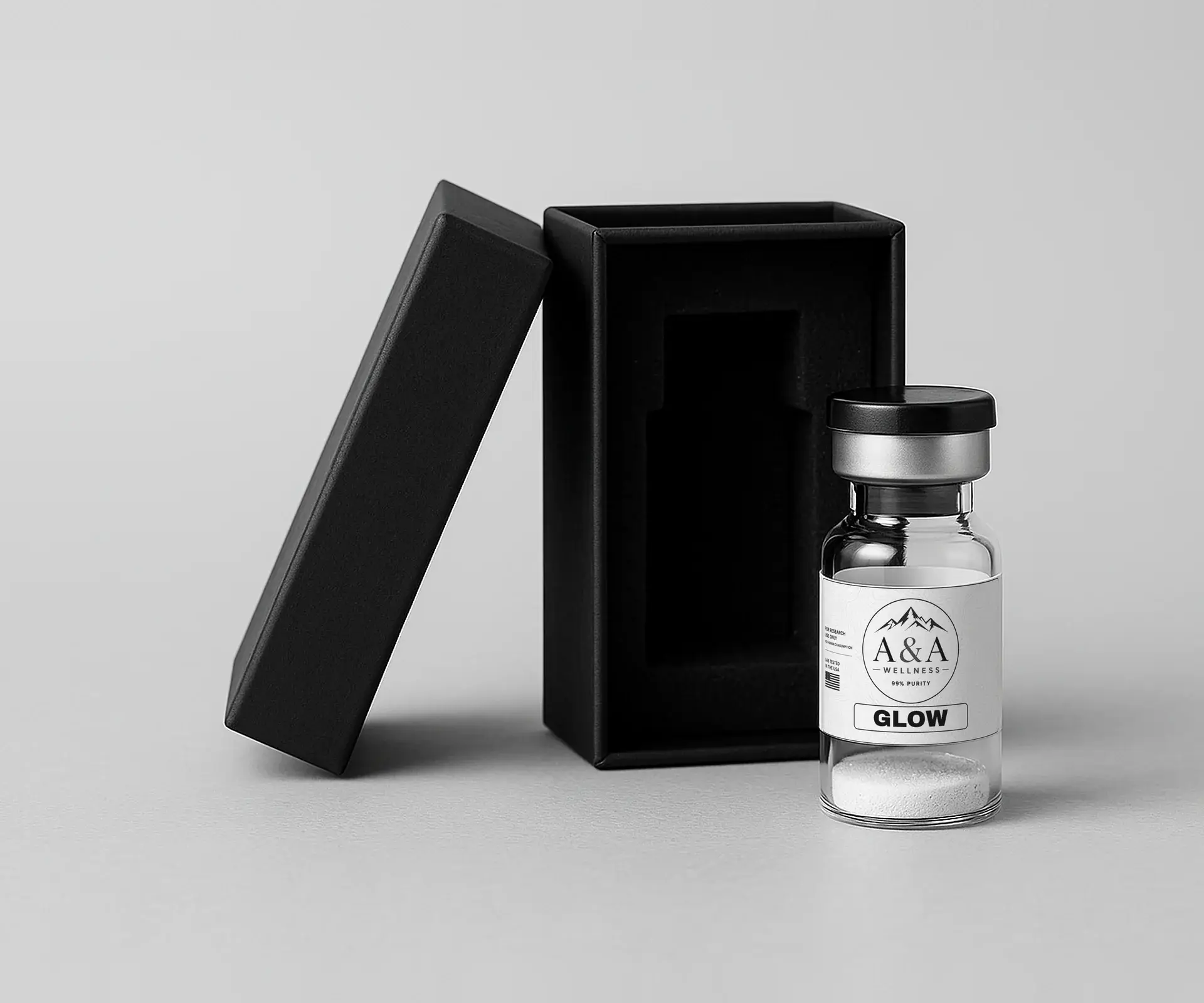 Plain black shipping box with a protective foam insert beside an A&A Wellness research vial
